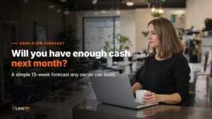 Salon owner reviewing her cash flow forecast on a laptop before opening